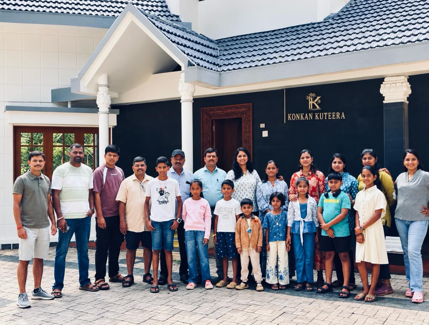 Cheerful group photo of guests celebrating special moments at Konkan Kuteera
